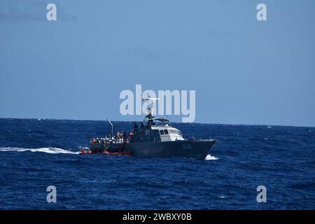 Coast Guard Cutter Joseph Napier’s small boat rendezvous with a Dominican Republic Navy vessel during the repatriation of 53 migrants to Dominican Republic, Jan. 12, 2023.  The migrant group was interdicted in the Mona Passage by Puerto Rico Police marine units, the Coast Guard Cutter Joseph Napier and a U.S. Customs and Border Protection multi-role enforcement aircraft the night of Jan. 10, 2024 near Cabo Rojo, Puerto Rico. (U.S. Coast Guard photo) Stock Photo