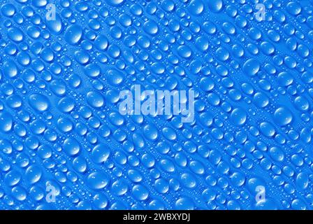 closeup, macro of many water drops, droplets, on a blue surface, background Stock Photo