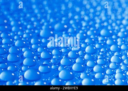 closeup, macro of many water drops, droplets, on a blue surface, background Stock Photo