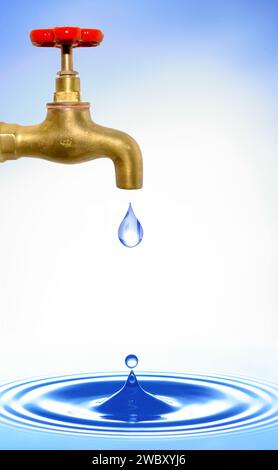 closeup of a golden brass water tap with red handle, water drop dripping off and causing circular waves on a water surface Stock Photo