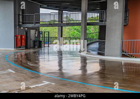 Parking garage, underground interior with a few parked cars. Neon light in bright industrial building. Interior of a parking lot in a shopping mall. m Stock Photo