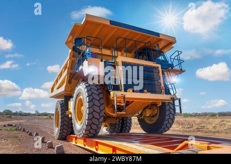 transport oversize load, loading a mining truck in a trailer to transport to a diamond mine Stock Photo