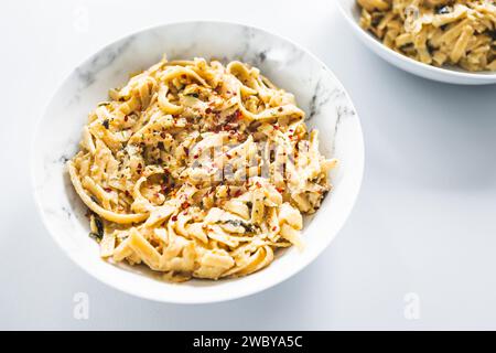 plant-based  fettuccini pasta with creamy lemon sauce, healthy vegan food recipes Stock Photo