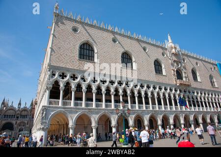 Venice Italy May 11 2011; Tourists along promenade by Doge's Palace built in Venetian gothic architectural stye Stock Photo