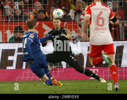 Munich, Germany. 12th Jan, 2024. Bayern Munich's goalkeeper Manuel Neuer (C) saves the shoot from Maximilian Beier (L) of Hoffenheim during the German first division Bundesliga football match between Bayern Munich and TSG Hoffenheim in Munich, Germany, Jan. 12, 2024. Credit: Philippe Ruiz/Xinhua/Alamy Live News Stock Photo