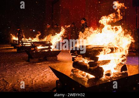 Vilnius, Lithuania. 12th Jan, 2024. Lithuanian soldiers stand on guard as bonfires burn at the Independence Square near the Lithuanian Parliament building on the eve of the 33rd anniversary of the Freedom Defenders Day in Vilnius. People gathered around the bonfire to remember the victims of assault by Soviet troops on the television center in Vilnius in 1991. The incident resulted in 14 deaths with many injured. The ceremonial lighting of bonfires took place near the Vilnius TV tower and at Independence Square. (Photo by Yauhen Yerchak/SOPA Images/Sipa USA) Credit: Sipa USA/Alamy Live News Stock Photo
