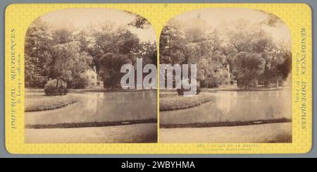 View of the lake and the mill in Le Hameau de la Reine at the Petit Trianon, Ernest Eléonor Pierre Lamy, 1860 - 1880 stereograph  The queen's hamlet cardboard. photographic support albumen print pond, pool. watermill The queen's hamlet Stock Photo