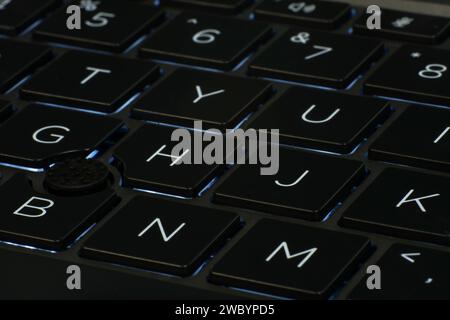 Low angle close up of laptop keyboard illumination, backlit keyboard Stock Photo