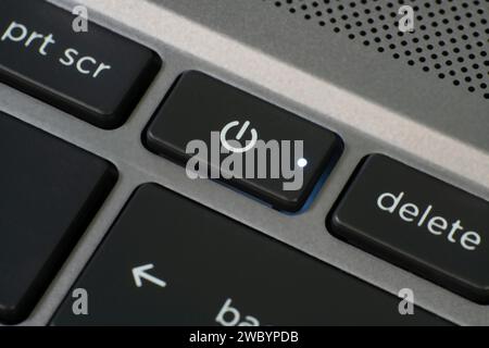 Close up of laptop power button with illuminated LED. Stock Photo