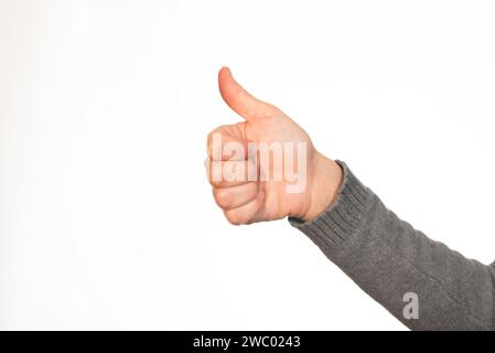Woman's hand showing thumbs up gesture Stock Photo