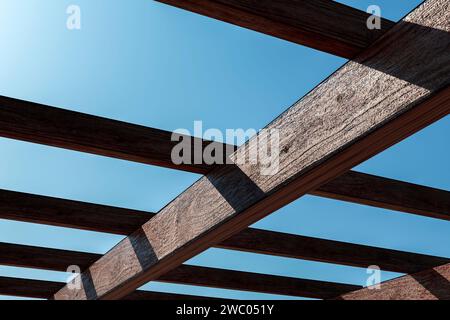 Wooden canopy roof structure made of colored polycarbonate. Stock Photo