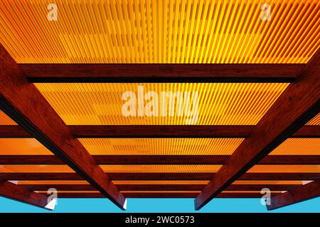 Wooden canopy roof structure made of colored polycarbonate. Stock Photo