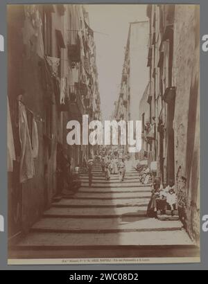 View of Via del Pallonttoa in Borgo Santa Lucia in Naples, Italy, Fratelli Alinari, 1890 - 1930 photograph  Naplespublisher: Florence paper albumen print sloping street; street with steps or stairs. hanging the wash to dry Borgo Santa Lucia Stock Photo