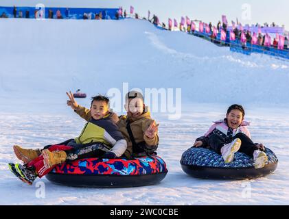 Visitors are experiencing the snow circle at the 3rd Hohhot Joy Ice and Snow Festival in Hohhot, Inner Mongolia, China, on January 12, 2024. (Photo by Costfoto/NurPhoto) Credit: NurPhoto SRL/Alamy Live News Stock Photo