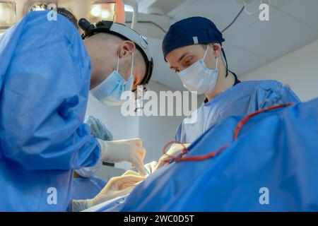 male surgeons perform surgery in operating room, plastic surgeon in operating room Stock Photo