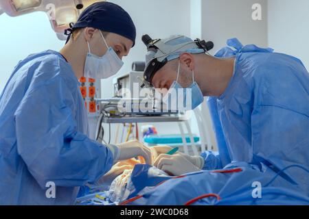 male surgeons perform surgery in operating room, plastic surgeon in operating room Stock Photo