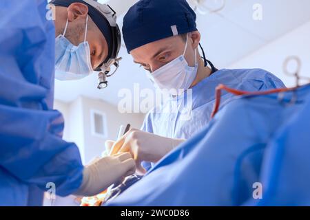 male surgeons perform surgery in operating room, plastic surgeon in operating room Stock Photo