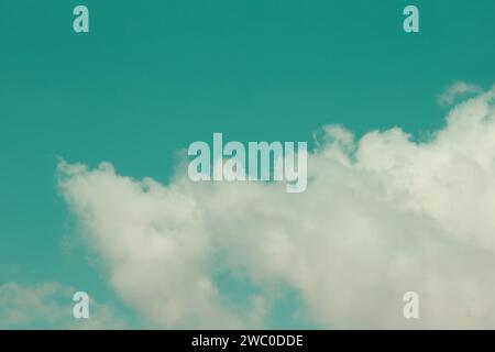 Vintage sky in emerald tint with white clouds Stock Photo