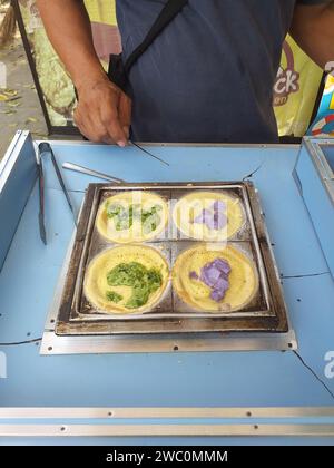 Indonesian Street Food Cart of Gerobak in Bandung, West Java, Indonesia selling Martabak Mini. Stock Photo