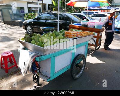 Indonesian Street Food Cart of Gerobak in Bandung, West Java, Indonesia selling mangoes or mangga. Stock Photo