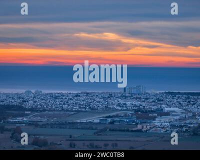 Sunrise with red sky over the urbanization of Empuriabrava and the bay of Roses in an aerial view (Alt Empordà, Girona, Catalonia, Spain) Stock Photo