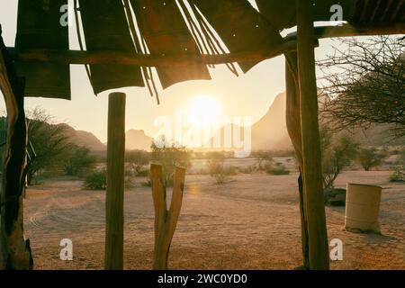 The sun sets behind the rocks at Spitzkoppe in Namibia Stock Photo