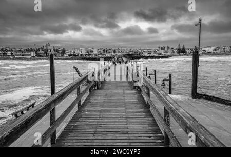 Looking back towards the town of Swakopmund from the long Victorian era Jetty in Namibia Stock Photo