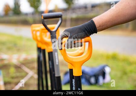 A man's hand in a black glove grasping a shovel Stock Photo
