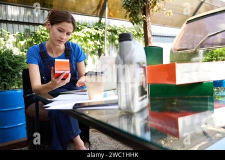 Woman sits with a laptop in a green recreation area Stock Photo