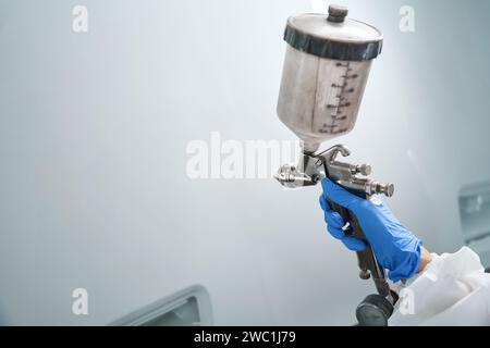 Professional machine for painting car in the hands of master Stock Photo