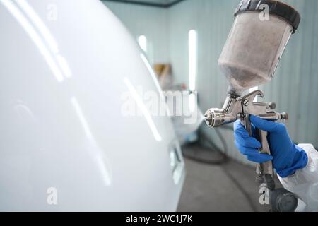 Process of painting a car with a special painting apparatus Stock Photo