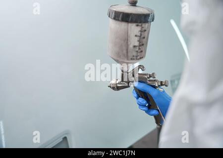 Professional paint injection tank is in the hands of master Stock Photo