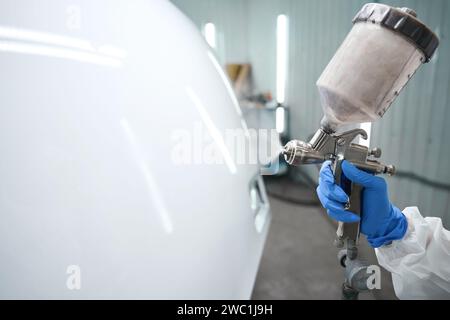 Process of painting a car with a painting apparatus Stock Photo