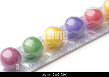 Closeup of colorful chewing gum balls in stick pack on white background Stock Photo