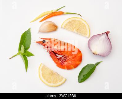 Single red cooked prawn or shrimp with spice or seasoning in set prepared for Thai prawn soup is isolated on white background. Stock Photo