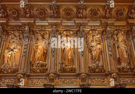 Malaga, Spain - July 30, 2022:  Detail of the wooden sculptures of saints in the choir of the Malaga Cathedral (or Santa Iglesia Catedral Basílica de Stock Photo