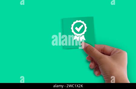 Hand shows the sign of the top service Quality assurance 5 star on green background Guarantee, Standards, ISO certification and standardization concep Stock Photo