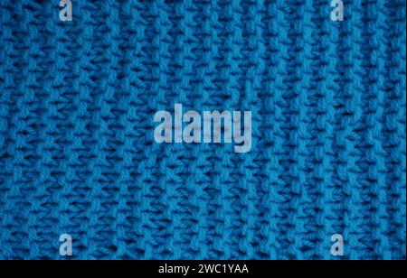Abstract background of blue knitted woolen threads close-up... Stock Photo
