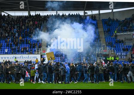 Reading, UK, 13th January 2024. The EFL League One match between Reading and Port Vale is abandoned on 16 minutes as fans invade the pitch, protesting against the Reading Owners. Credit: TeeGeePix/Alamy Live News Stock Photo