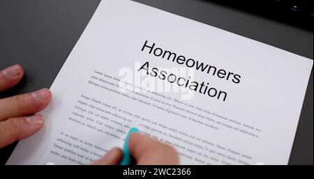 Person Reading HOA Rules And Regulations Document Stock Photo