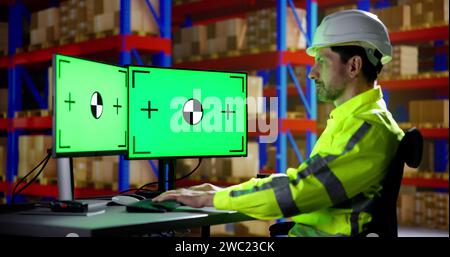 Engineer Using PC Monitor With Green Screen Stock Photo