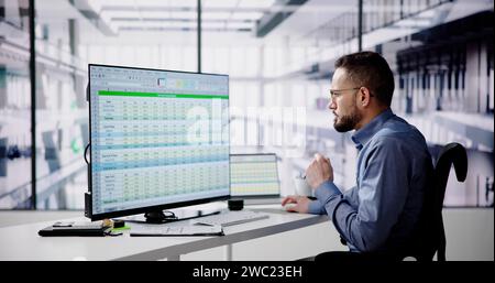 Data Analyst Man Using Spreadsheet On Computer Stock Photo