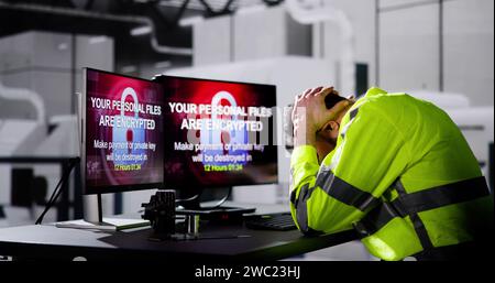 Shocked Engineer In Automated Semiconductor Factory During Ransomware Attack Stock Photo