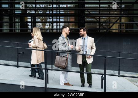 Group of young business people product strategy experts waiting for staff meeting with employer from human resources for job search in front of office Stock Photo