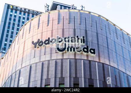 The hugh Yodobashi electronics superstore in Osaka, Japan. Close up of the brand name logo high on the top part of the exterior of the building. Stock Photo