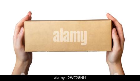 Kraft box in hand. Holding narrow rectangle-shaped cardboard isolated on white Stock Photo