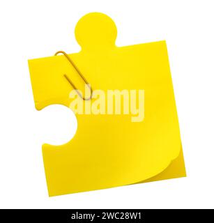 Tear-off sheets of paper for notes in the shape of a puzzle on a white background. Yellow note paper isolate Stock Photo