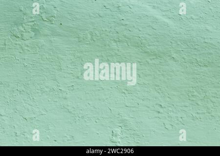Green Textured Wall Background . The surface of the old pastel green plaster. Stock Photo