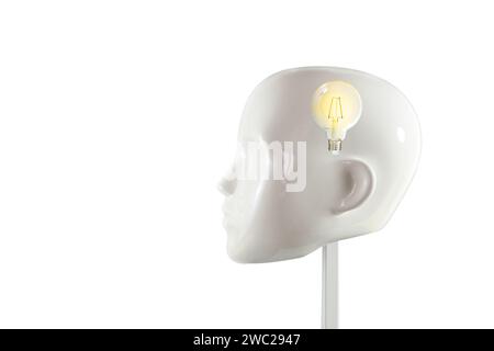 Glowing light bulb inside a head of a white mannequin doll, concept for ideas, mind, insight, realization and creativity, isolated on white, copy spac Stock Photo