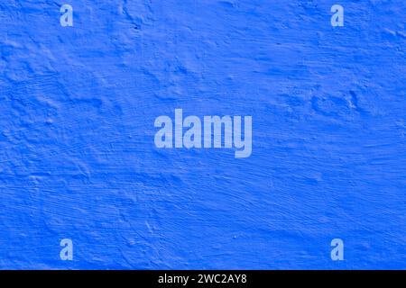 Surface of damaged blue plaster. Surface of blue plaster on the wall. Abstract background for design with copy space. Stock Photo